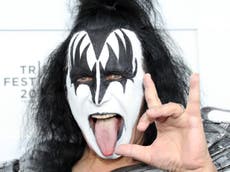 Gene Simmons performs from a chair after becoming ‘obviously sick’ during Kiss concert