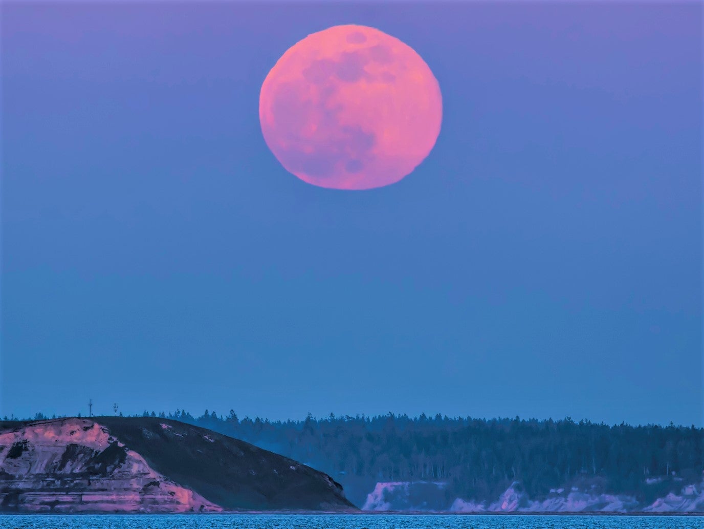 Pink supermoon rising over Protection Island Puget Sound, Strati of Juan de Fuca. This month’s full moon falls on 16 April, 2022