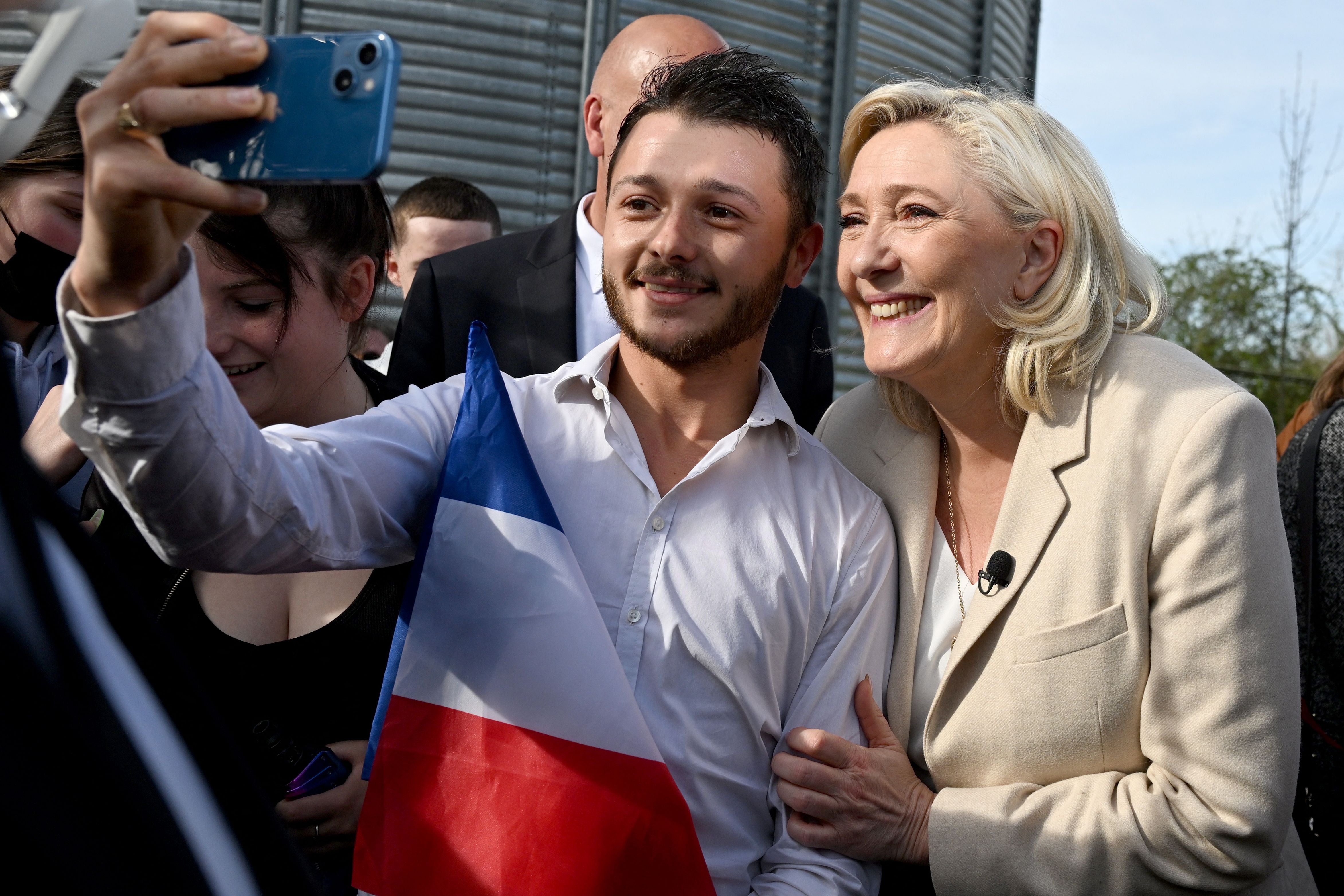 Marine Le Pen poses for a picture with a supporter during a visit at a grain farm Soucy, Burgundy, 11 April
