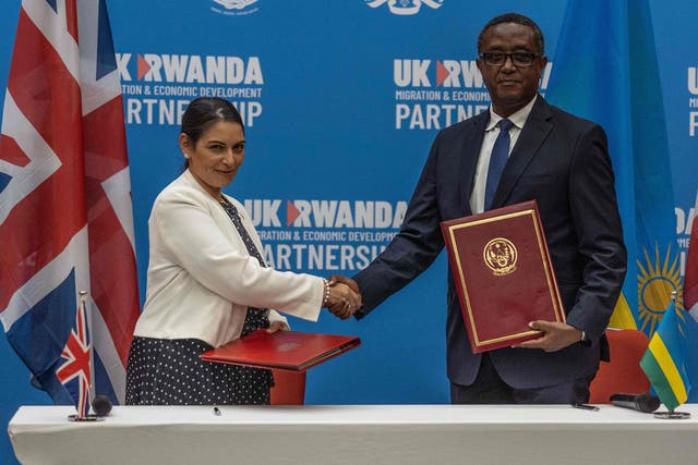 <p>Priti Patel, the home secretary, shakes hands with Rwandan minister of foreign affairs and international cooperation Vincent Biruta, after the African nation agreed to receive Britain’s asylum seekers </p>