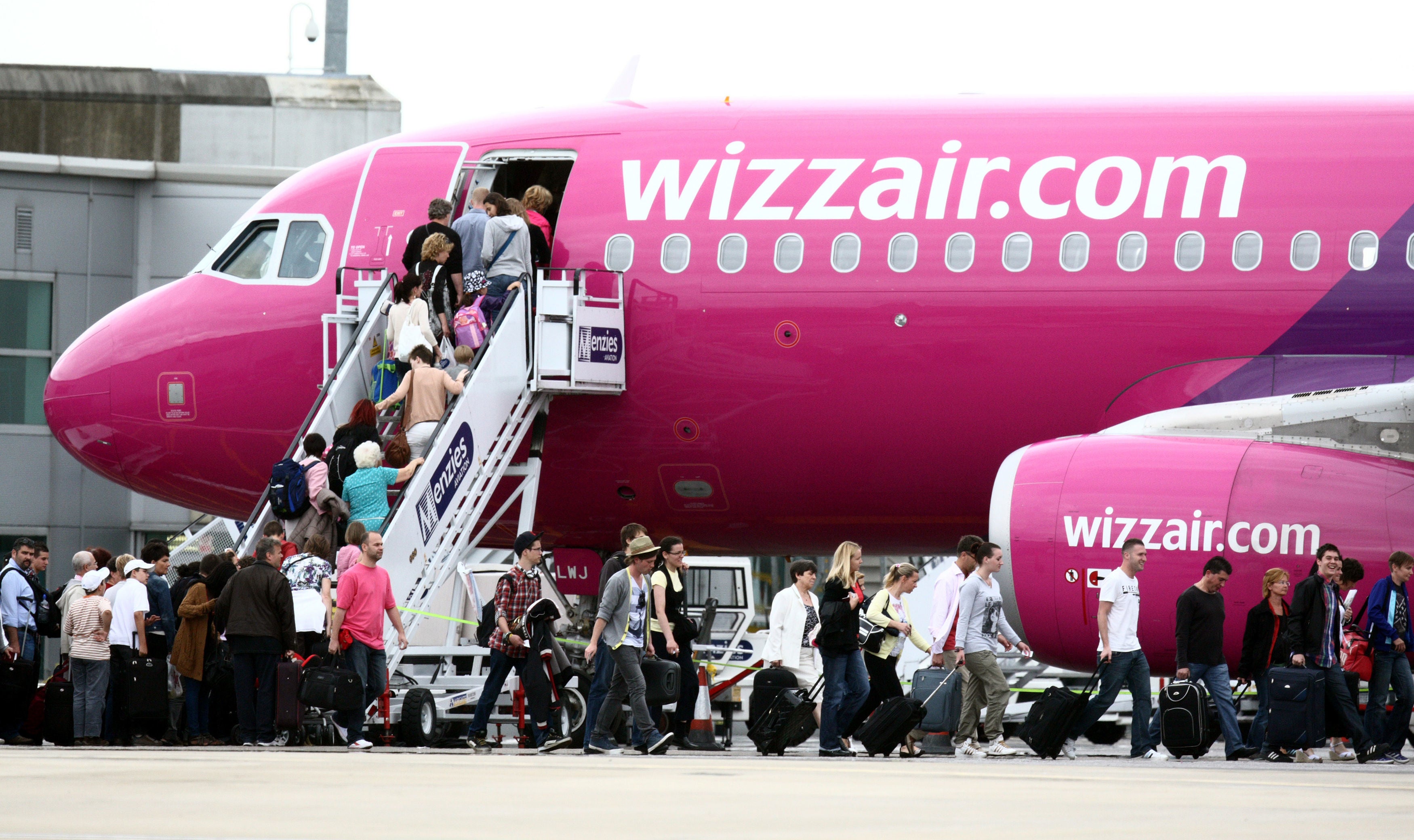 Passengers board a Wizz Air aircraft at London Luton Airport, where it serves 75 destinations
