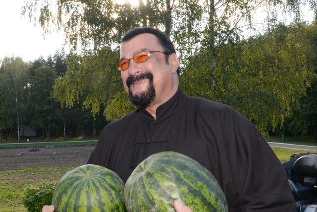 <p>The glimmer man: Steven Seagal poses with two watermelons in 2016, the year he was granted both Serbian and Russian citizenship</p>