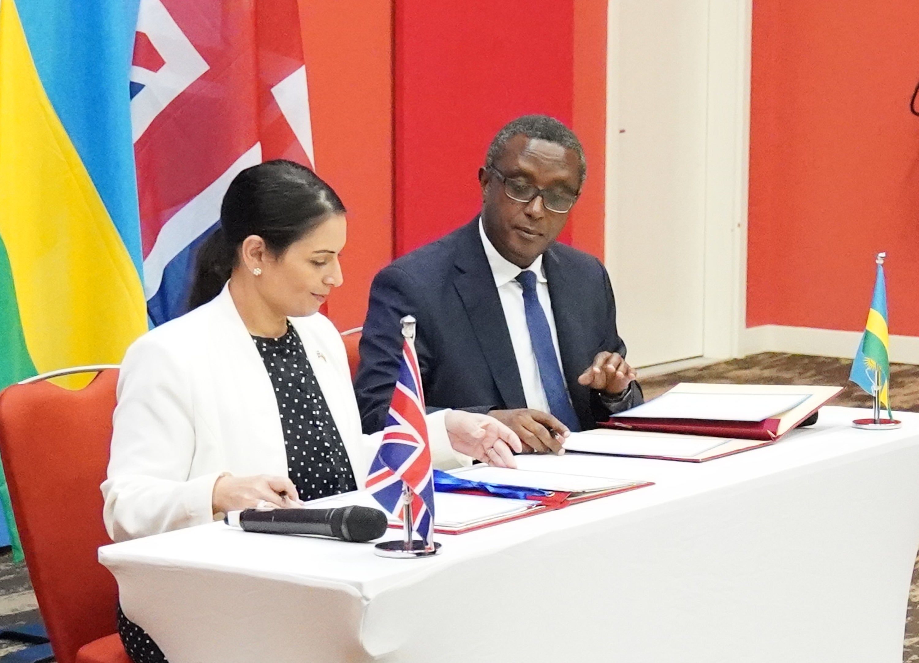 Home Secretary Priti Patel and Rwandan minister for foreign affairs and international co-operation, Vincent Biruta, sign a migration and economic development partnership (Flora Thompson/PA)