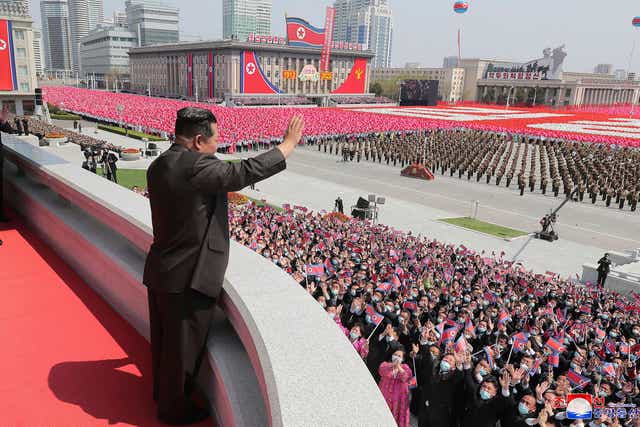 <p>North Korea’s Kim Jong-un waving from a balcony overlooking Kim II-sung Square on the 110th birth anniversary of his state-founding grandfather </p>
