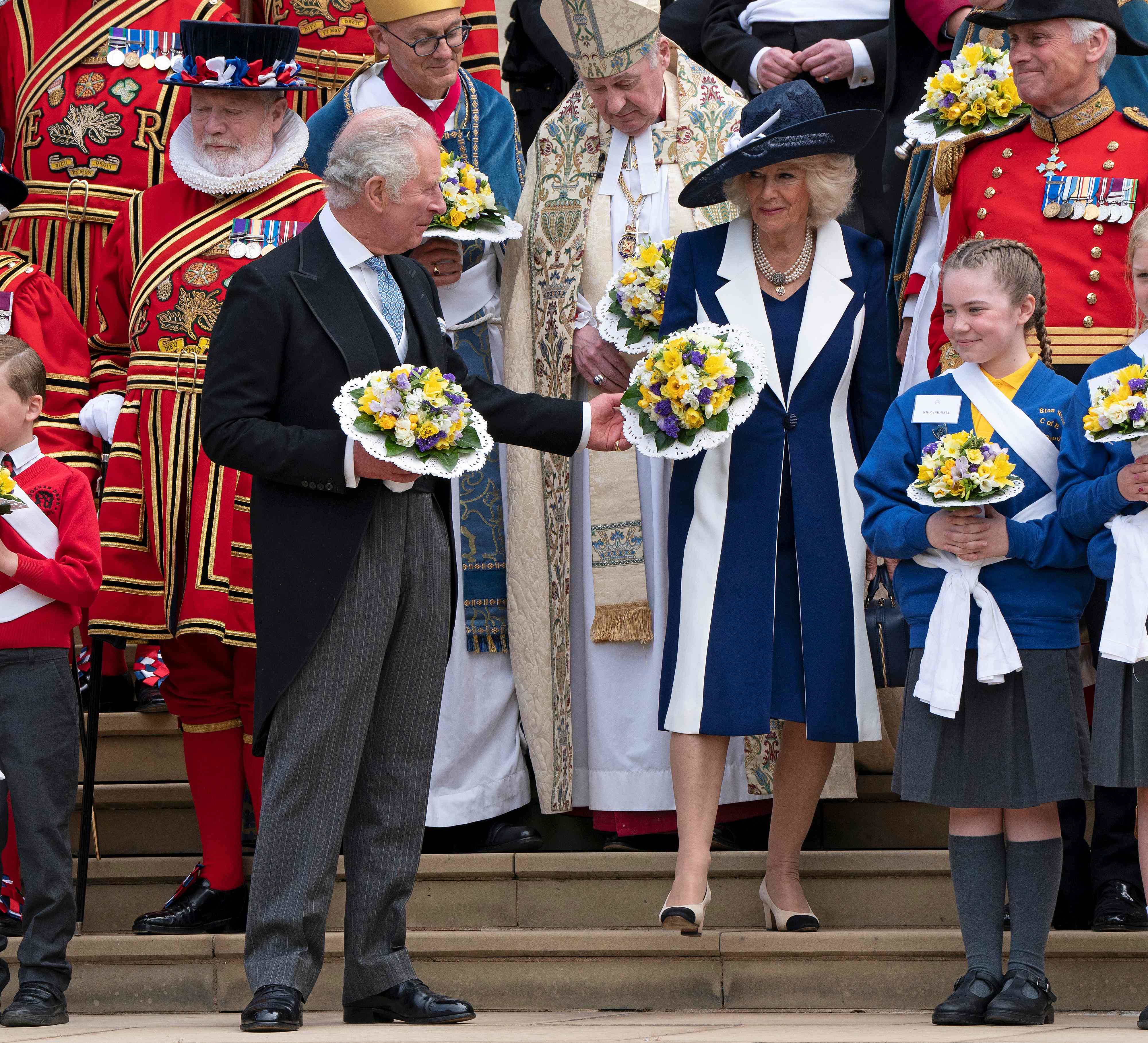 Prince Charles, Prince of Wales and Camilla, Duchess of Cornwall pose for a photograph with ‘Beefeater’ Yeomen Warders after taking part in the Royal Maundy Service at St George's Chapel in Windsor