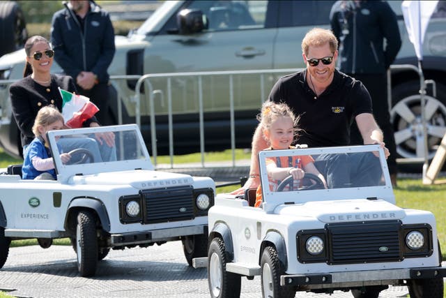 <p>Prince Harry and Meghan Markle are seen riding with kids in Land Rover Mini Defenders at the Jaguar Land Rover Driving Challenge on day one of the Invictus Games The Hague 2020 at Zuiderpark</p>