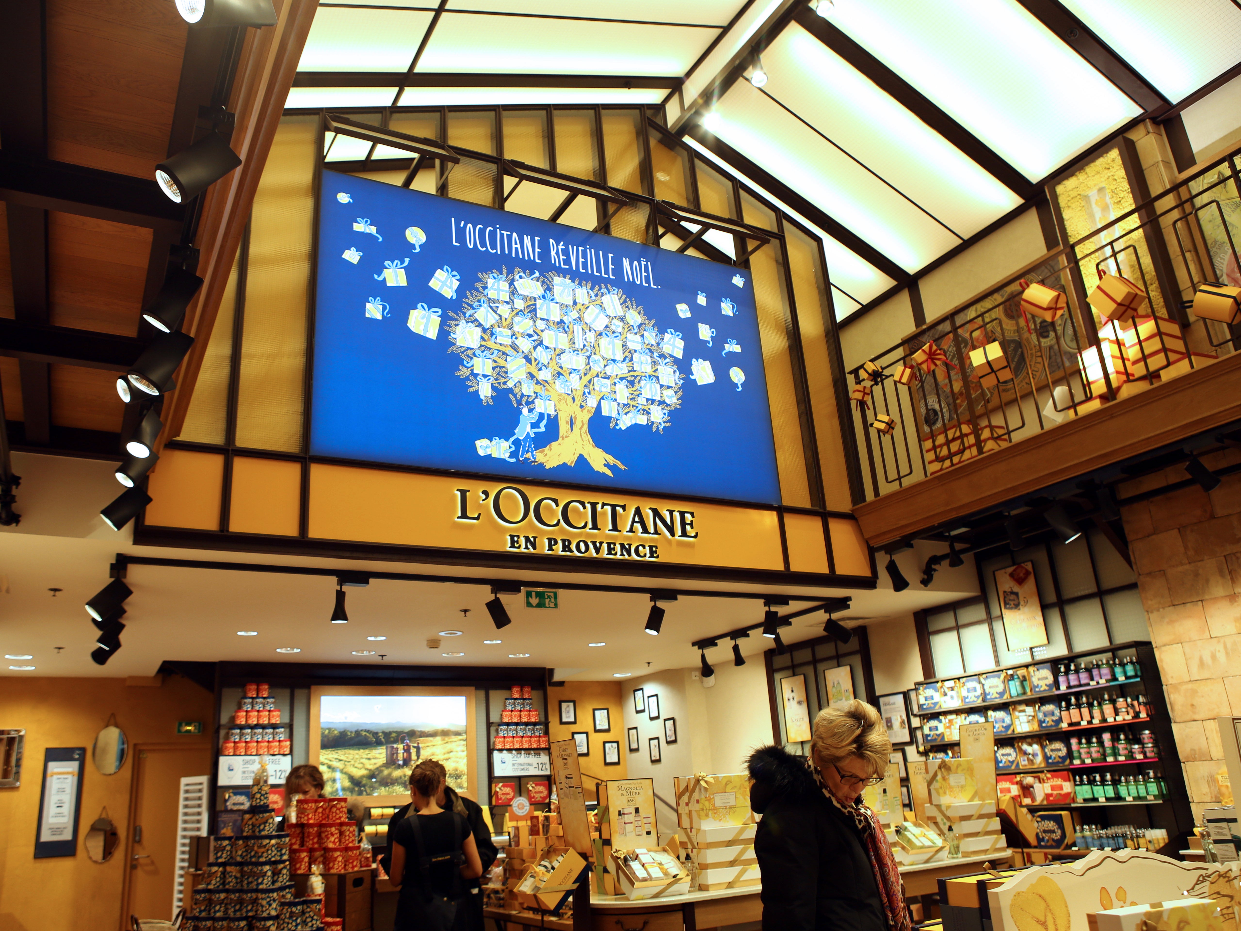 Customers shop in a store of French cosmetics company L'Occitane