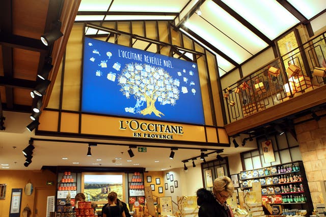 <p>Customers shop in a store of French cosmetics company L'Occitane</p>