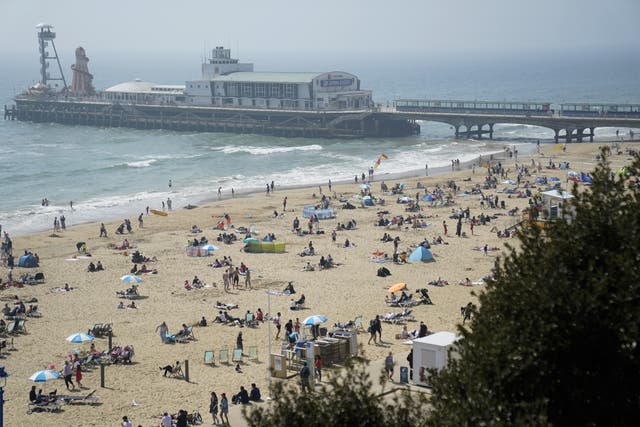 People enjoy the good weather at Bournemouth Beach in Dorset (Andrew Matthews/PA)
