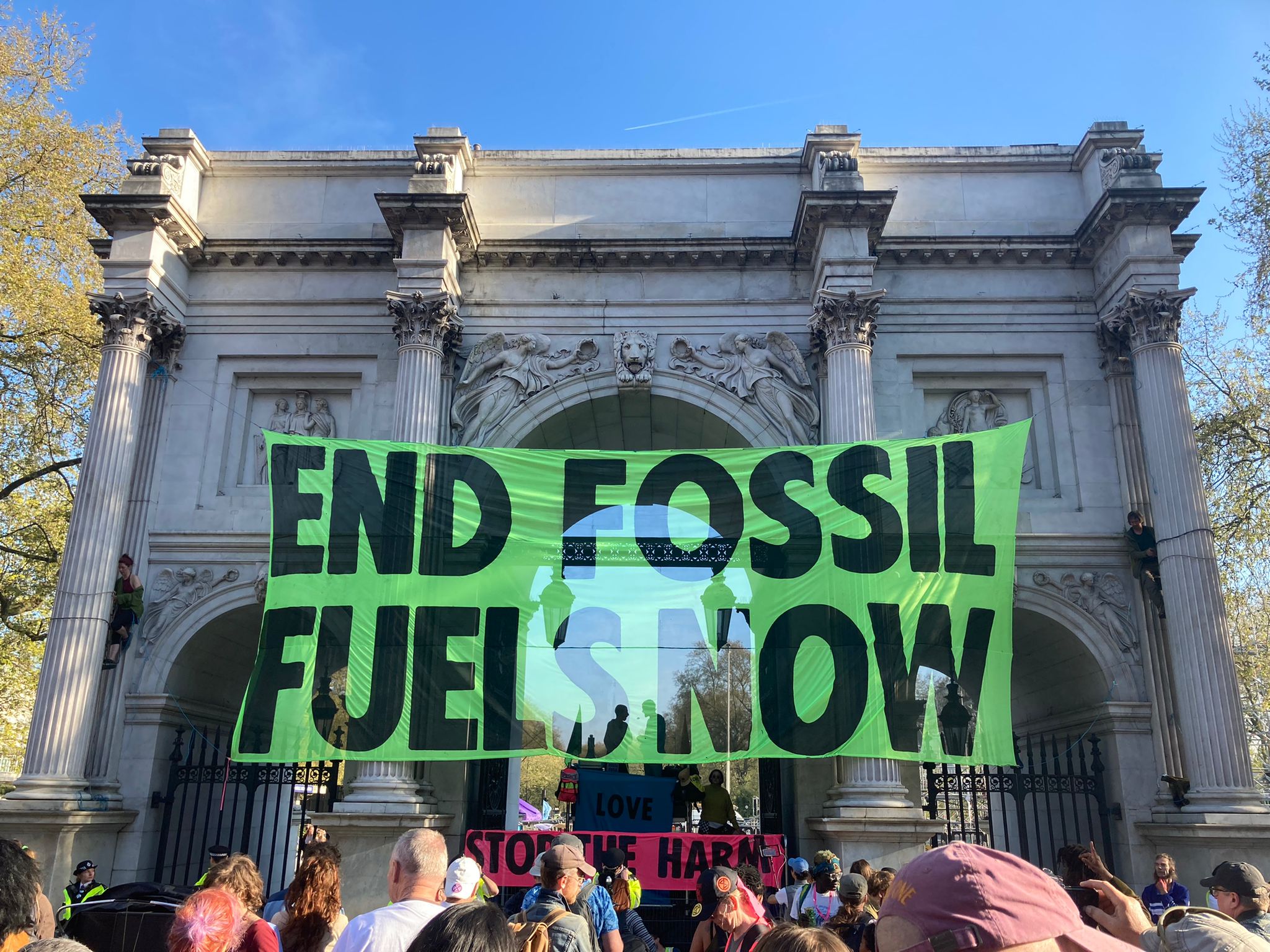 Activists hang a banner from Marble Arch in London on Saturday