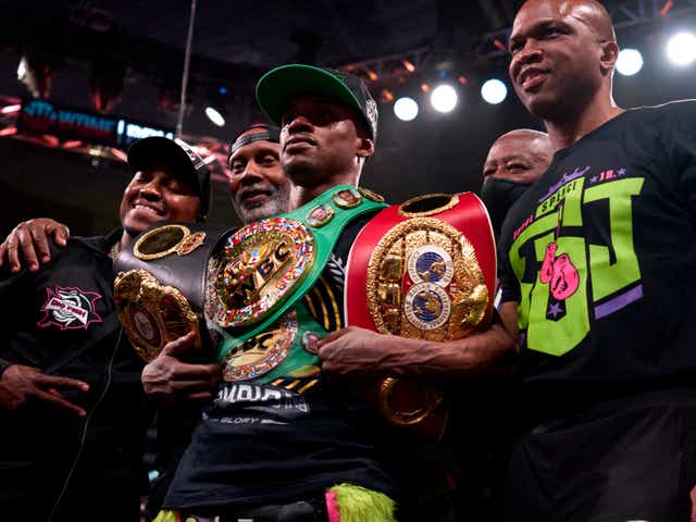 <p>Errol Spence Jr (centre) celebrates after collecting another welterweight belt</p>