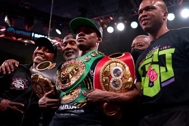 <p>Errol Spence Jr (centre) celebrates after collecting another welterweight belt</p>