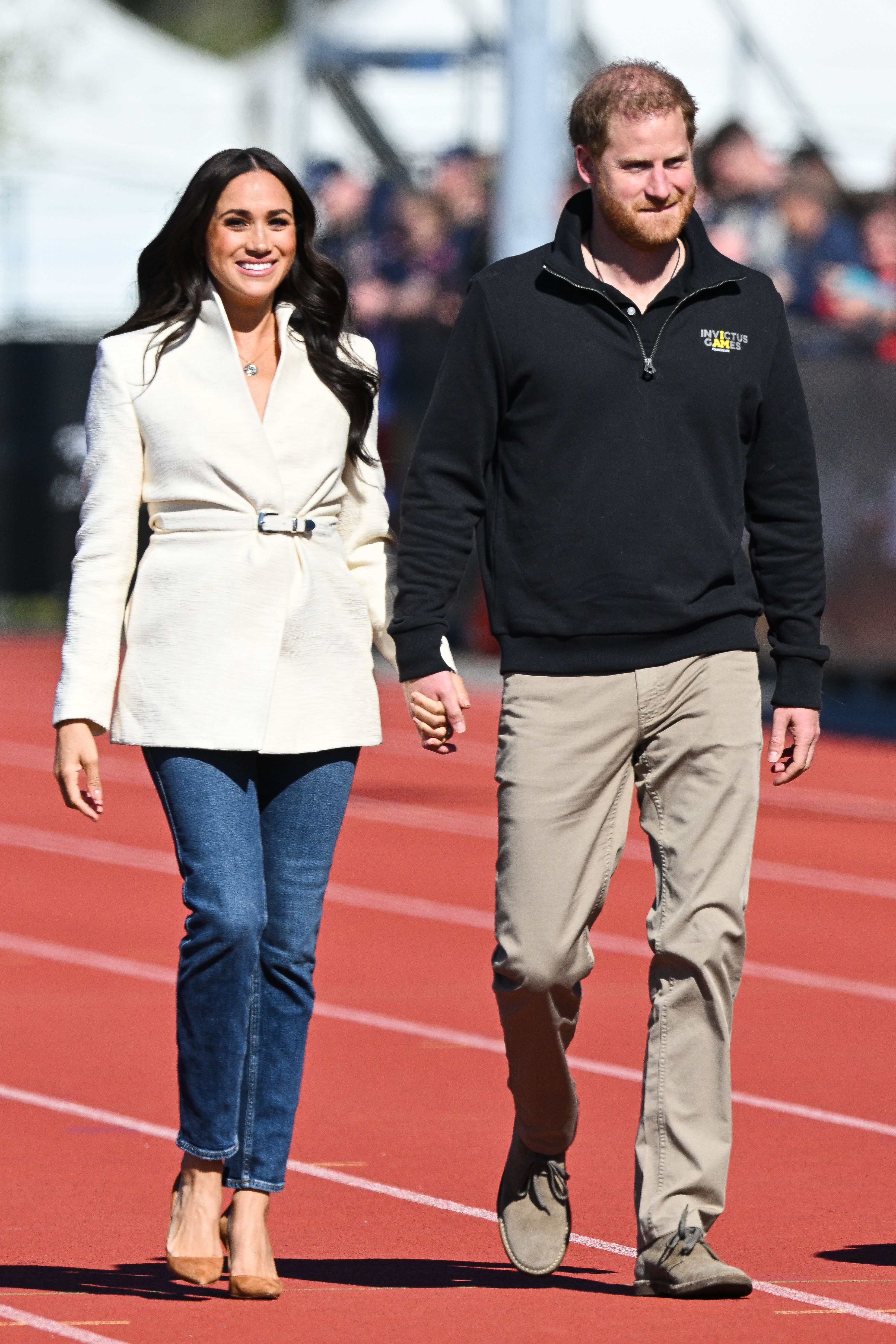 Meghan was all smiles as the couple arrived to watch the games