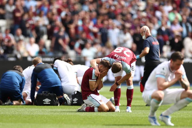 <p>West Ham’s Nikola Vlasic is in tears while Ashley Westwood of Burnley receives treatment</p>