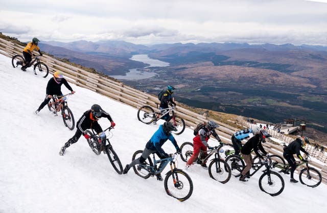 Cyclists take part in MacAvalanche, a mass start mountain bike race through the snow, descending over 900m from the summit of Aonach Mor in the Nevis Range near Fort William