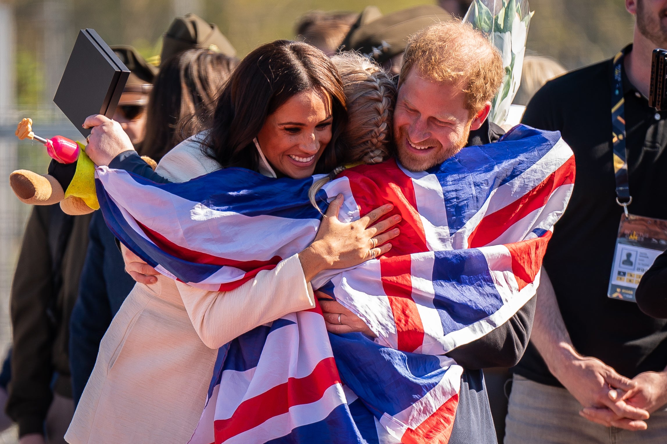 The Duke and Duchess of Sussex hug Lisa Johnston (Aaron Chown/PA)