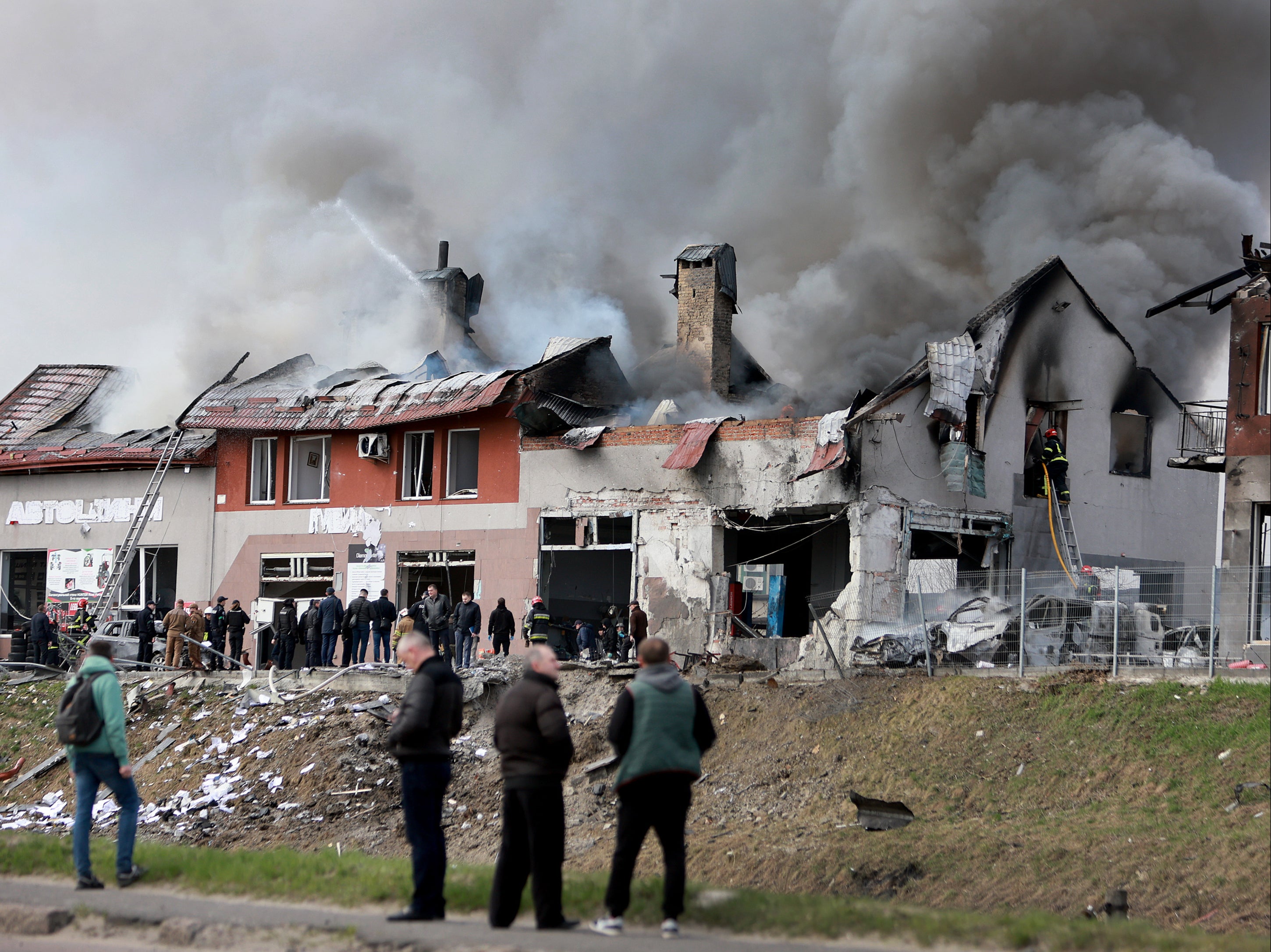 Firefighters battle a blaze after a civilian building was hit by a Russian missile in Lviv