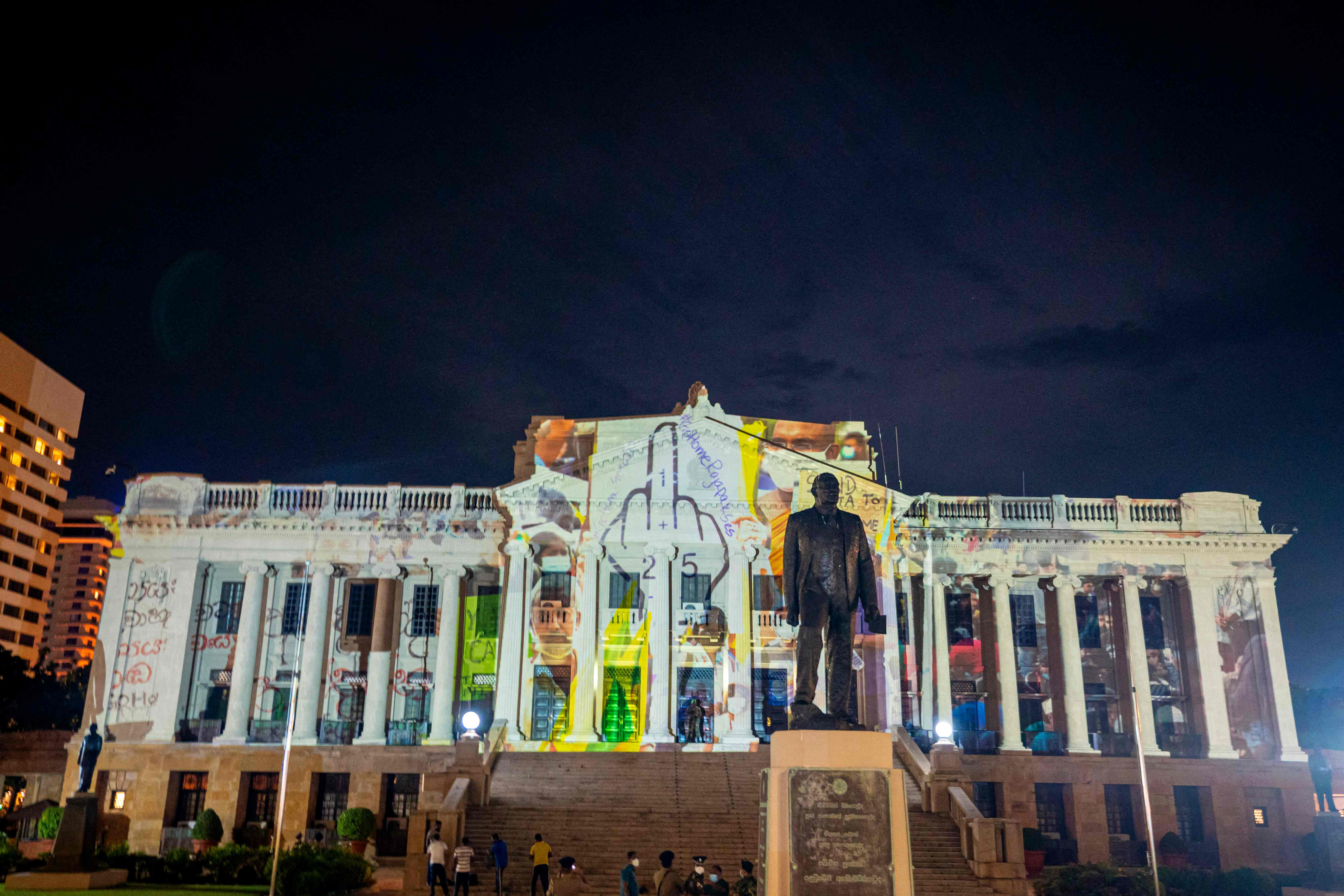 Anti-government protesters project messages on the facade of president Gotabaya Rajapaksa’s sea-front office in Colombo