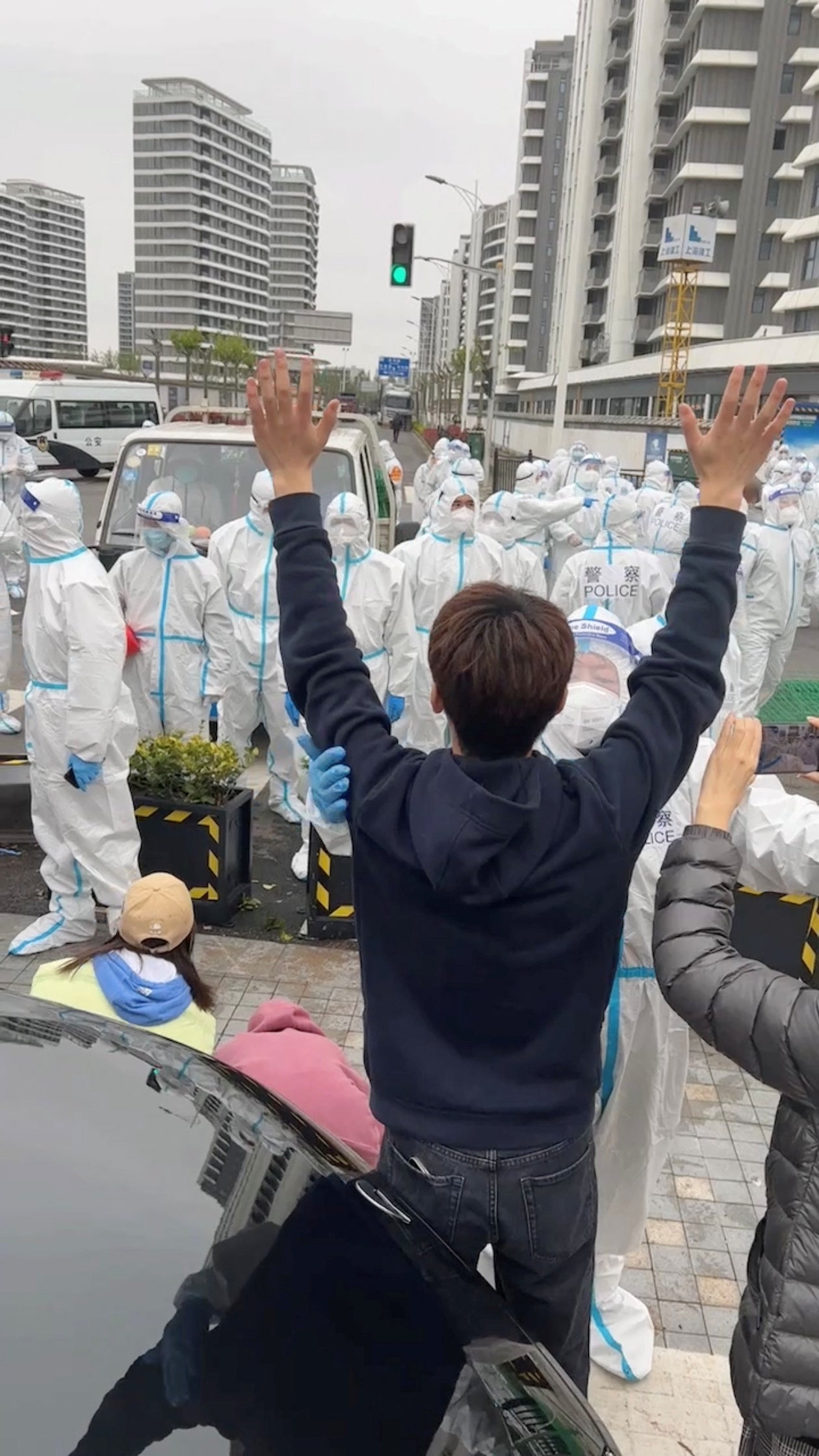 A protester demonstrates against Shanghai residential compounds being turned into isolation facilities