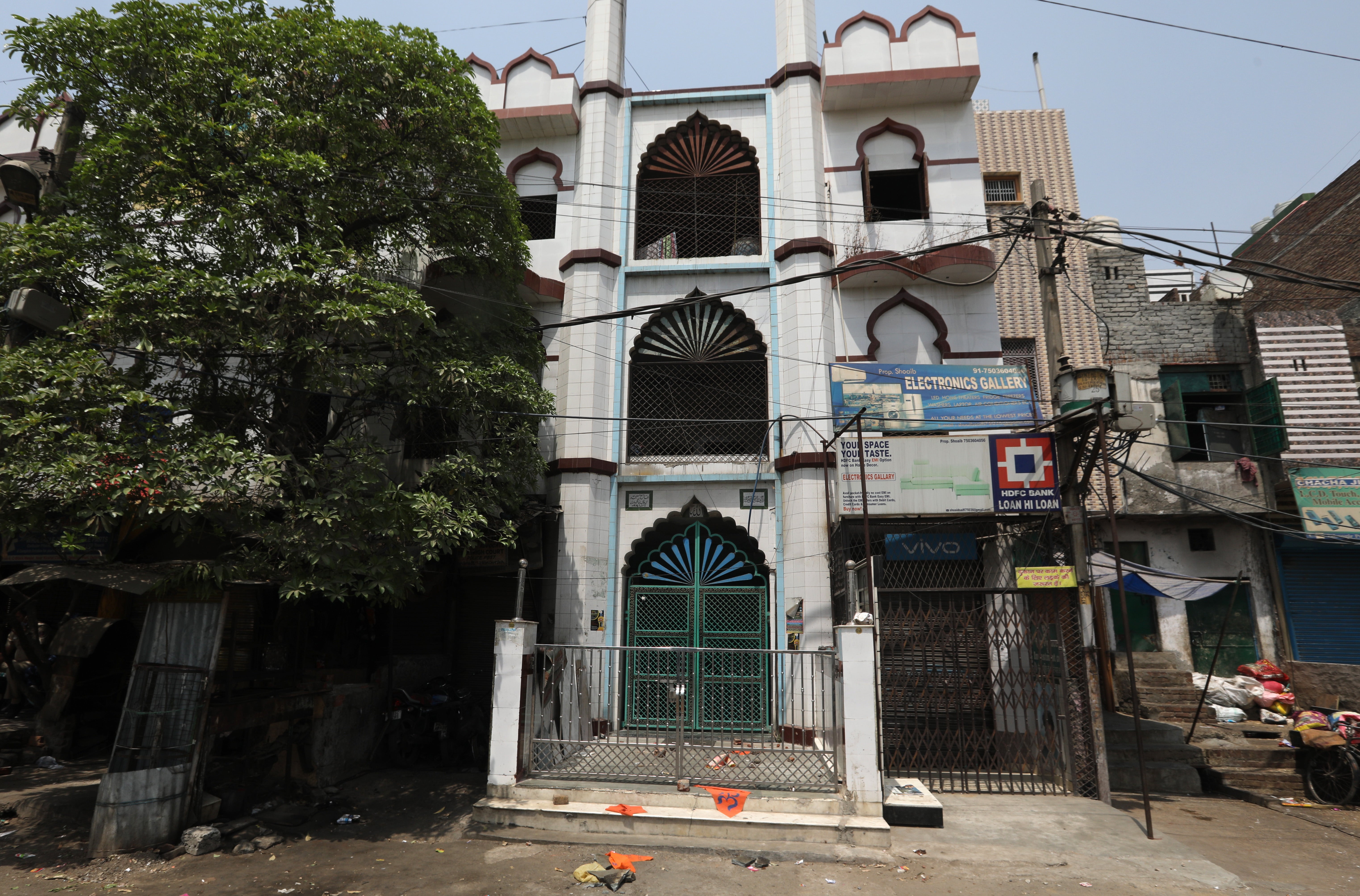 Hindu religious flags outside a mosque in Jahangirpuri after violence during a Hindu religious procession