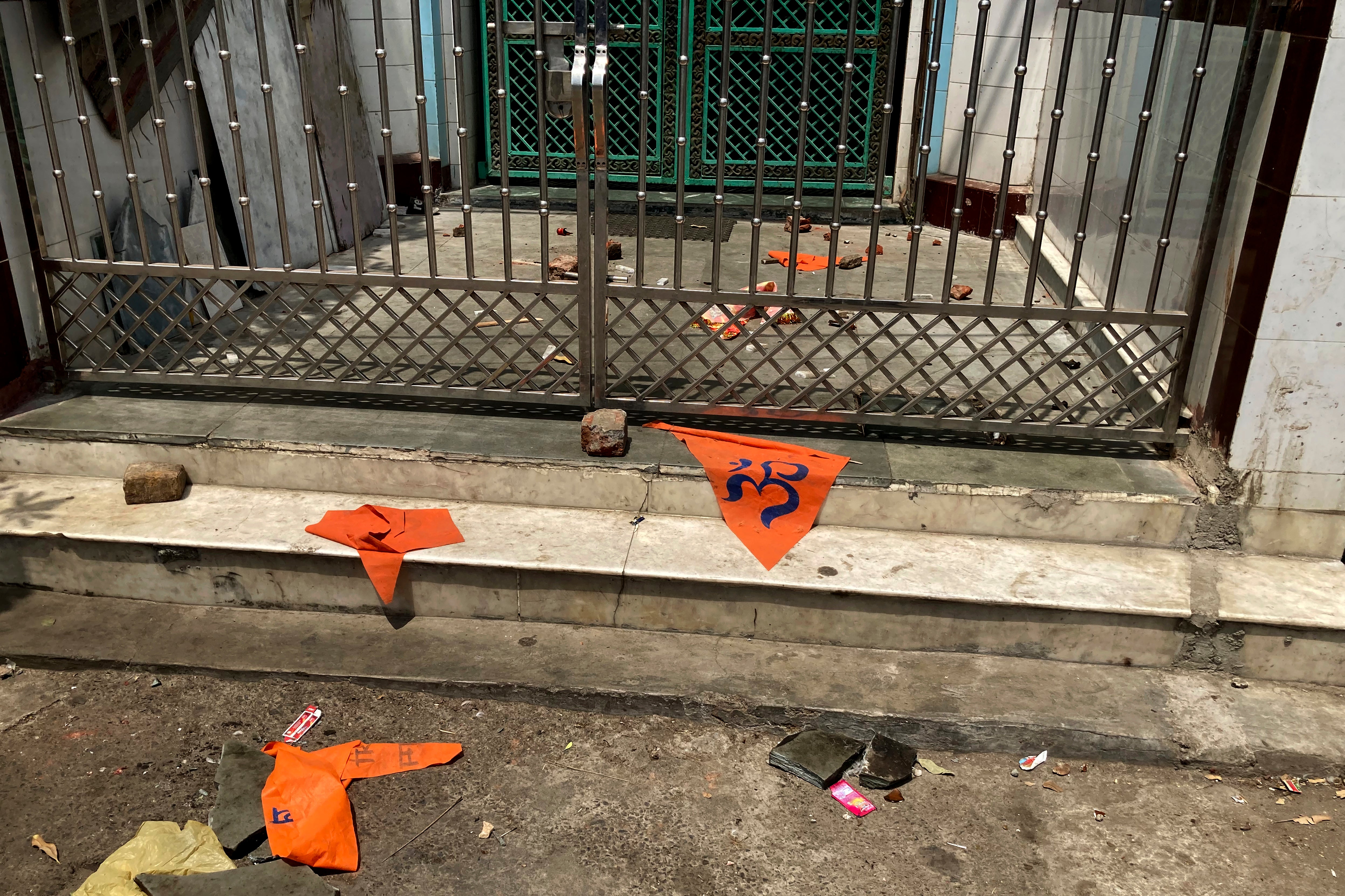 Saffron-coloured flags lie outside a mosque the day after clashes in the Jahangirpuri neighbourhood of Delhi