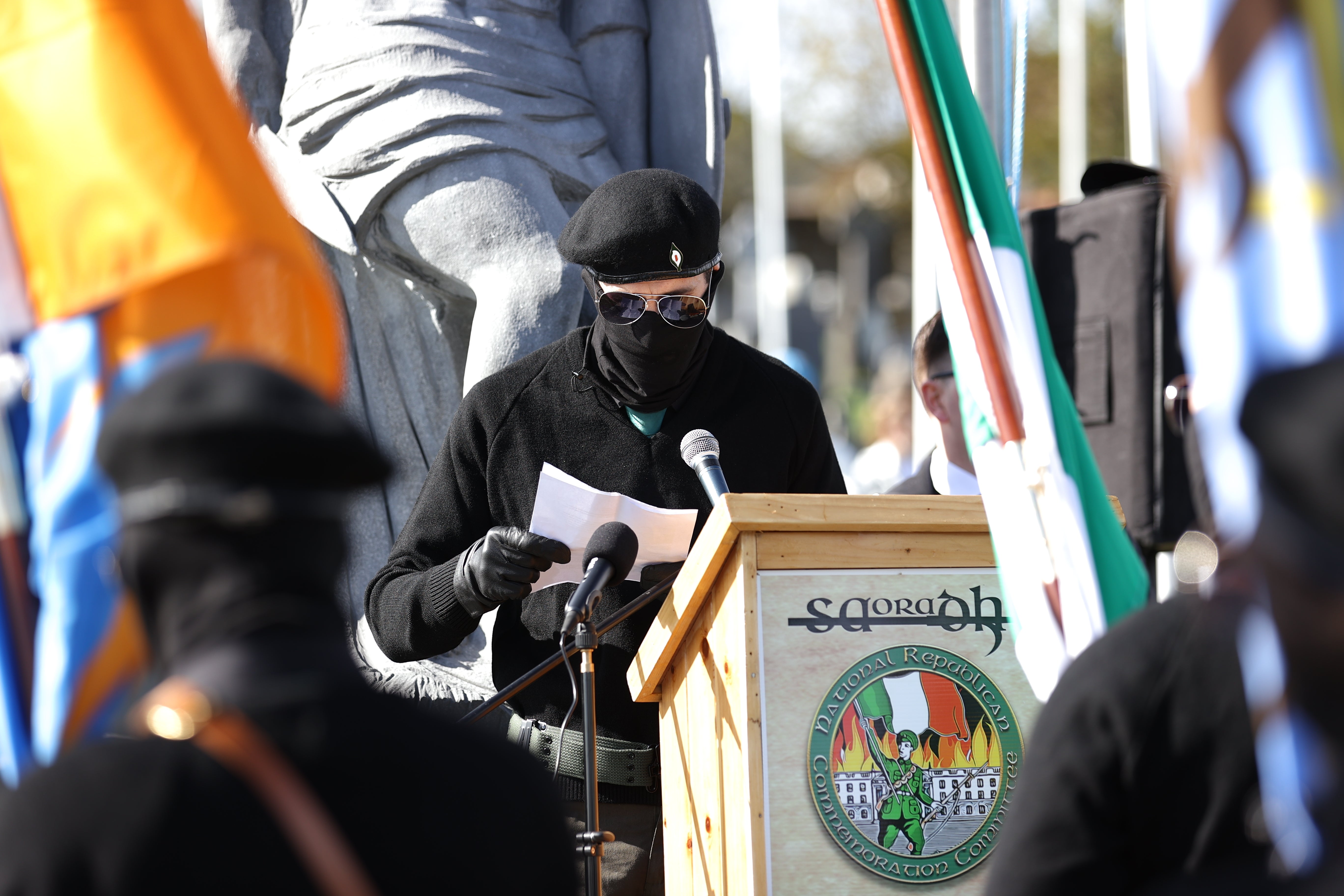 An Saoradh Colour Party member speaking at the City Cemetery in Londonderry (Liam McBurney/PA)