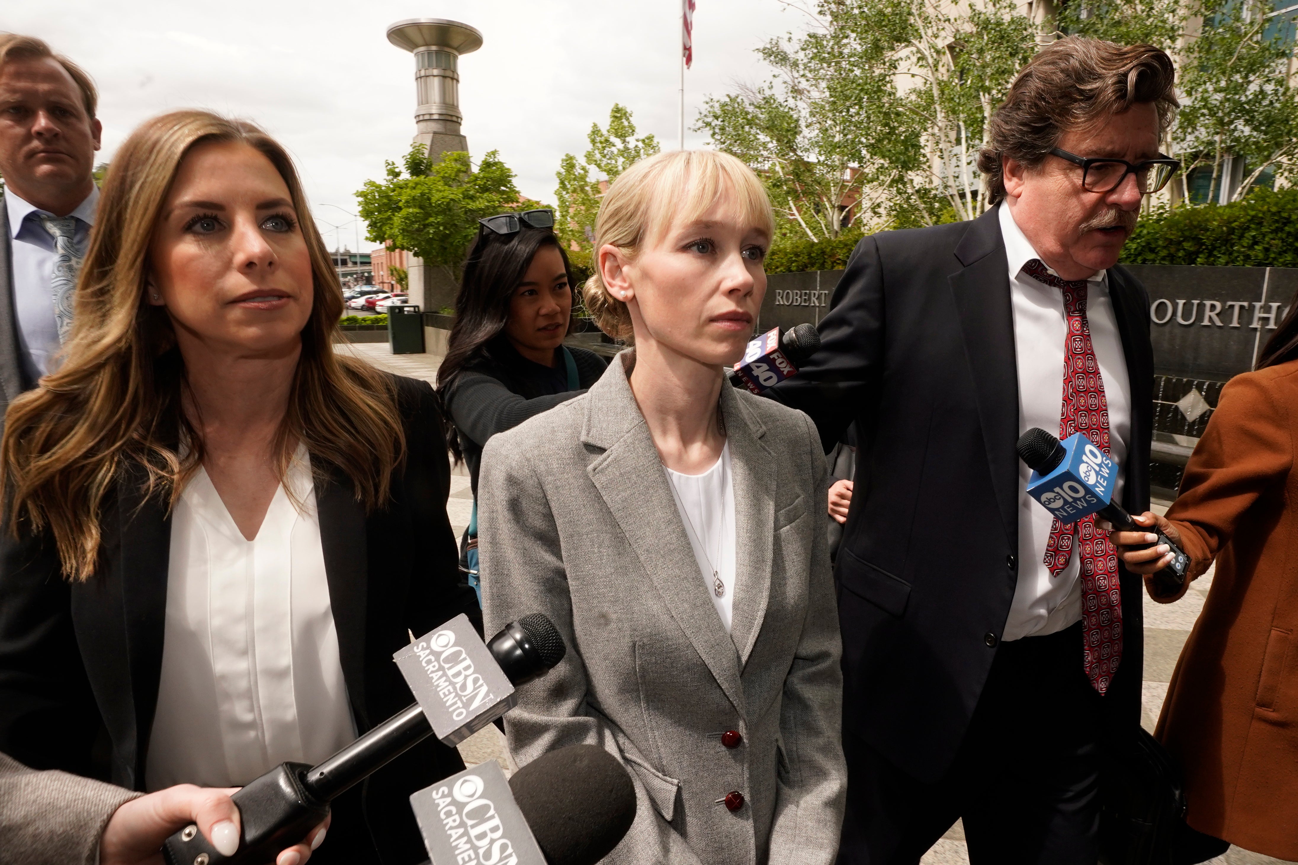 Sherri Papini of Redding leaves the federal courthouse accompanied by her attorney, William Portanova, right, in Sacramento, Calif., April 13, 2022