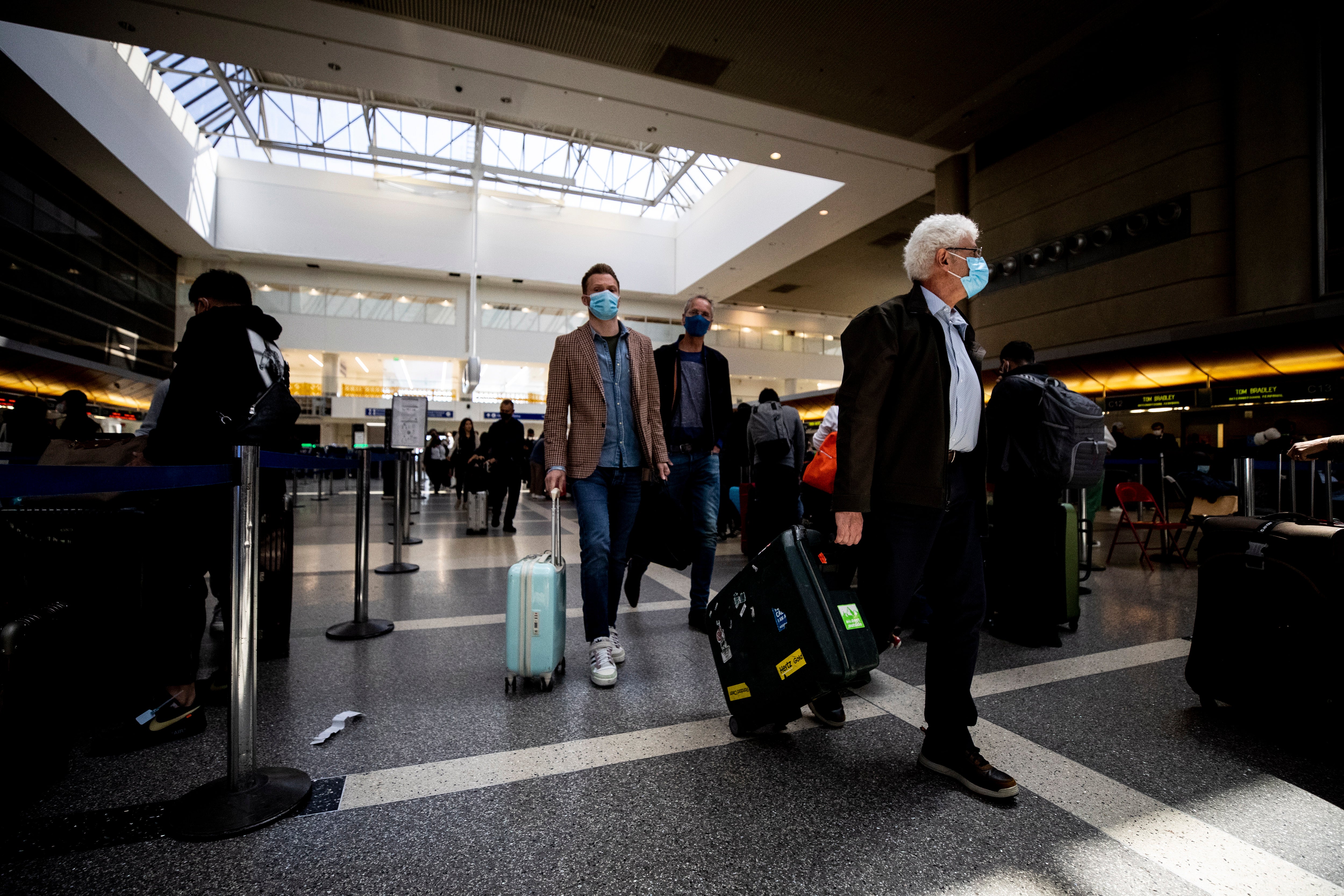Passengers wear masks at the International flights terminal of the Los Angeles Airport, in Los Angeles, California, USA, 13 April 2022.