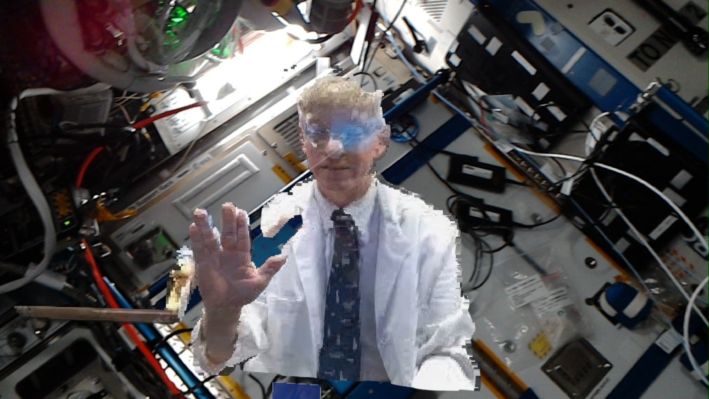 Nasa flight surgeon Dr Josef Schmid gives a space greeting on 8 October 2021 as he is holoported to the International Space Station