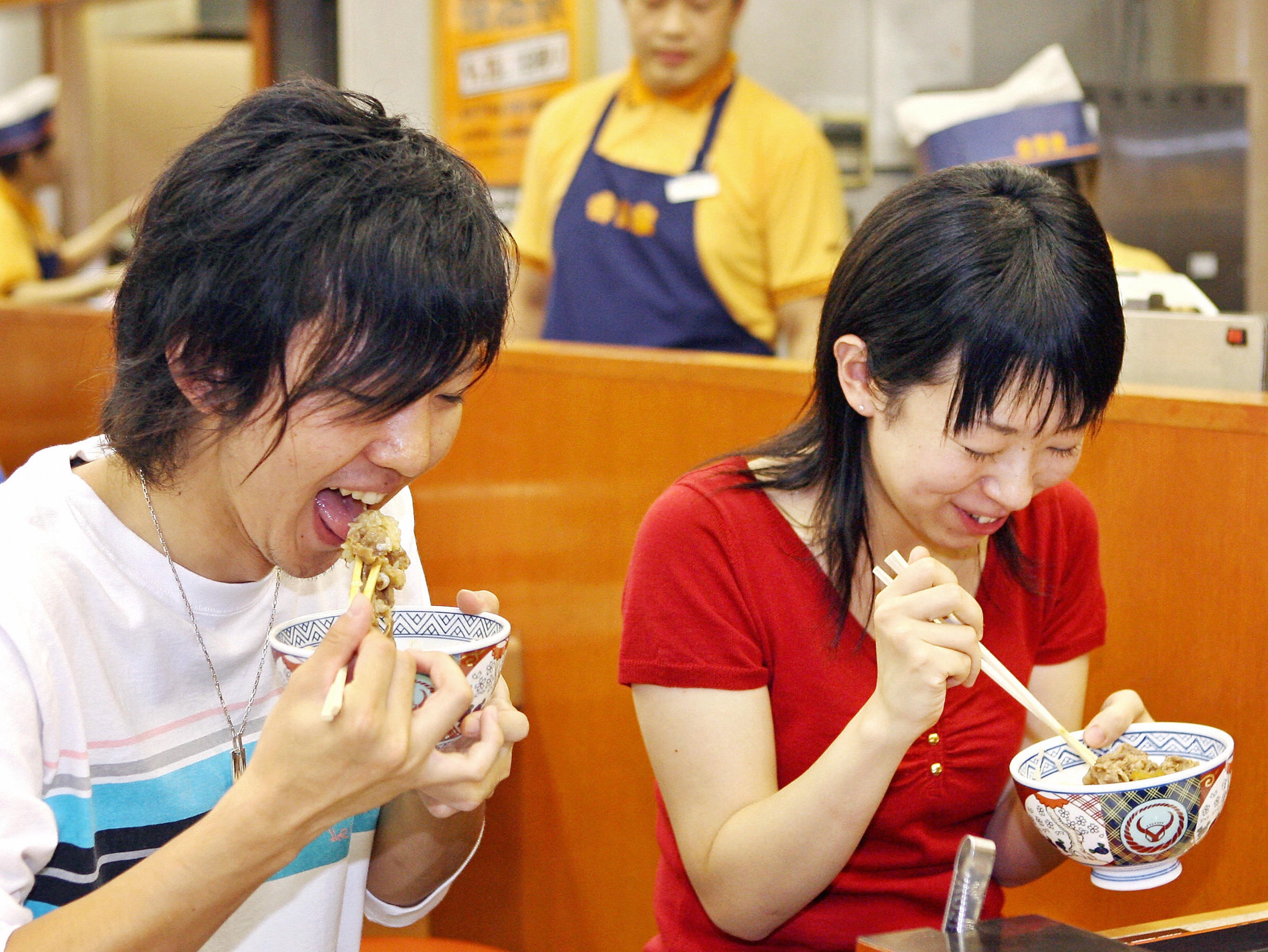 File A Japanese couple enjoy bowls of “gyudon”, a beef and rice dish commonly referred to as beef bowls, at a Yoshinoya fast food restaurant