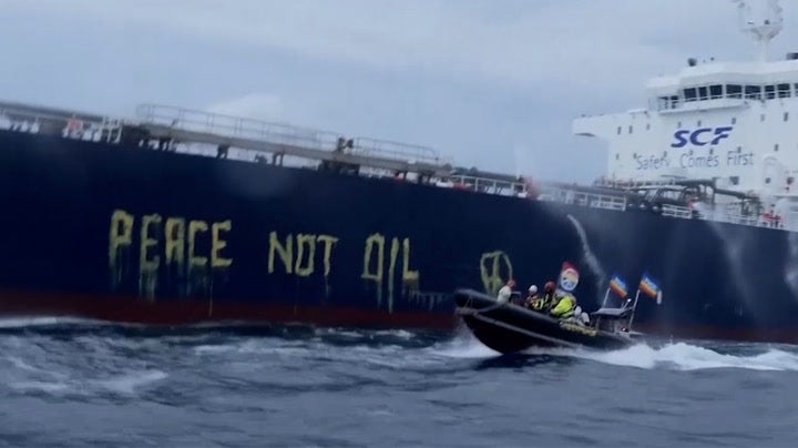 Greenpeace activists write ‘peace, not oil’ on side of Russian ship