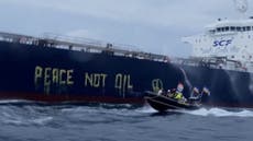 Greenpeace activists write ‘peace, not oil’ on side of Russian ship