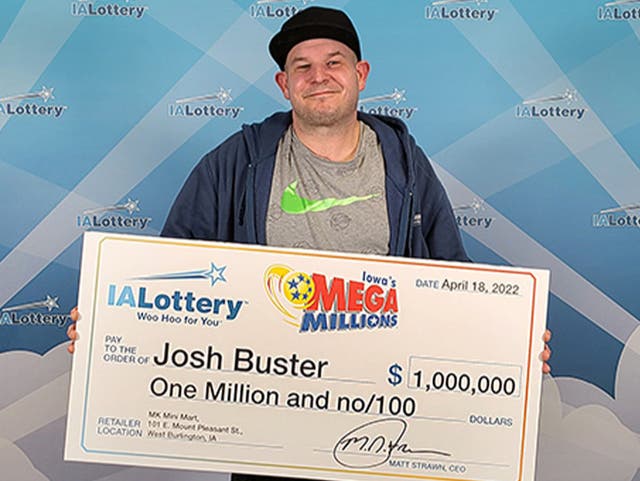 <p>John Buster with his Iowa lottery cheque </p>