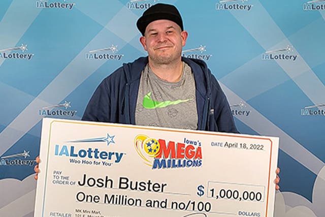 <p>John Buster with his Iowa lottery cheque </p>