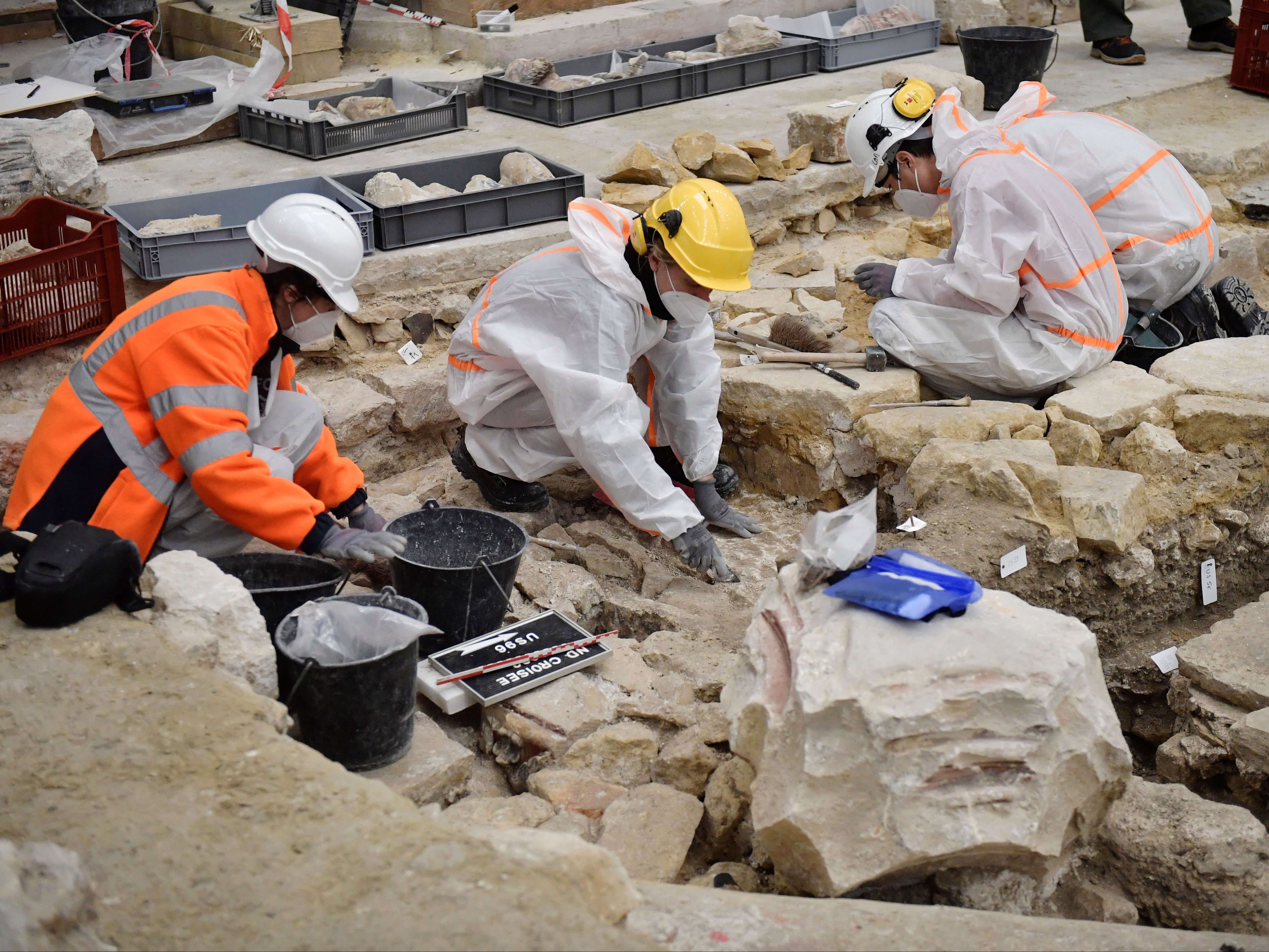 Archaeologists excavate the floor of the cathedral after the discovery of the sarcophagus