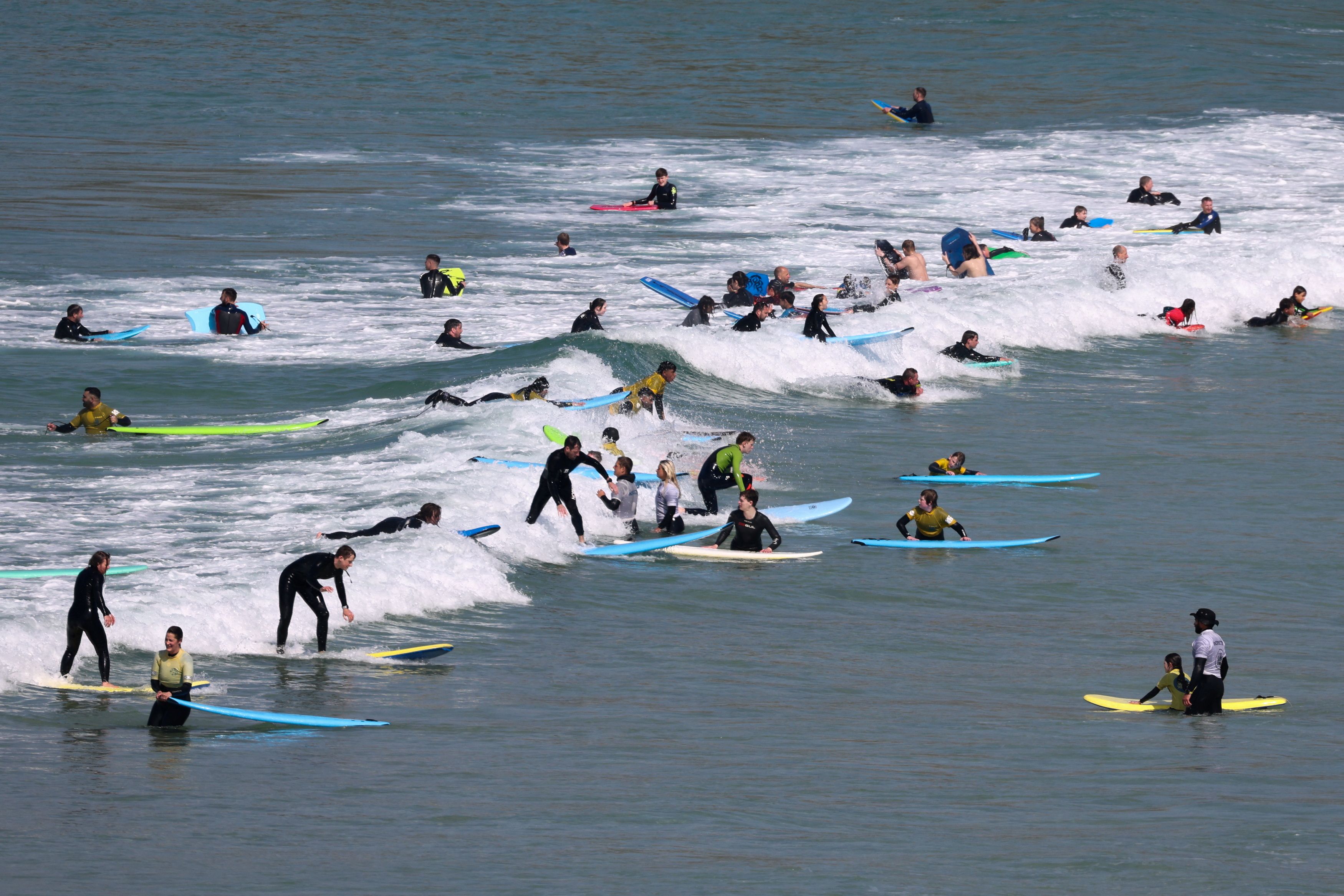 People surf at Porthmeor beach during hot weather on Easter bank holiday weekend in St Ives