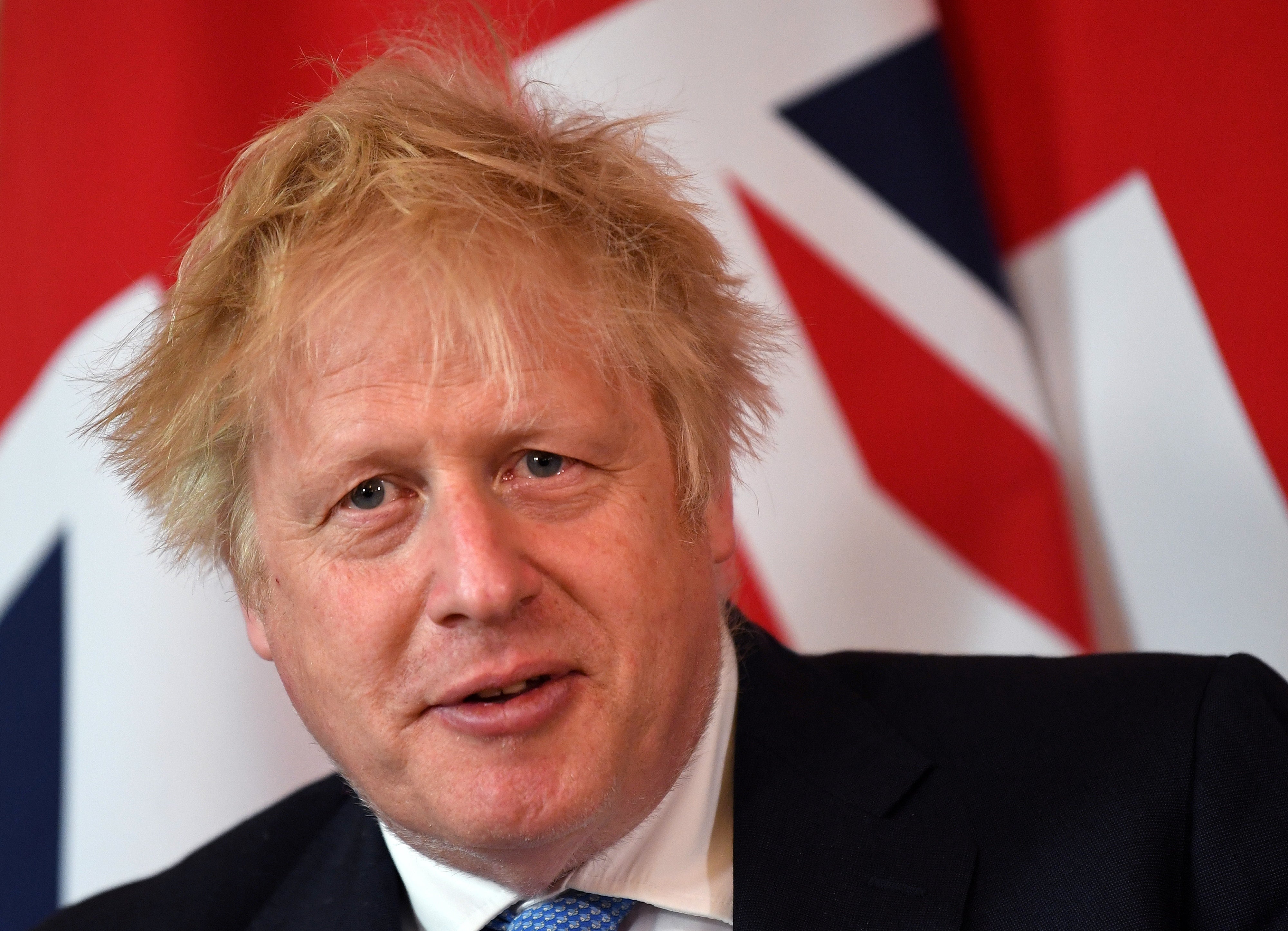 Boris Johnson is seeking to push ahead with his visit to India this week despite it clashing with a key Commons vote on whether he lied to Parliament about coronavirus breaches (PA)
