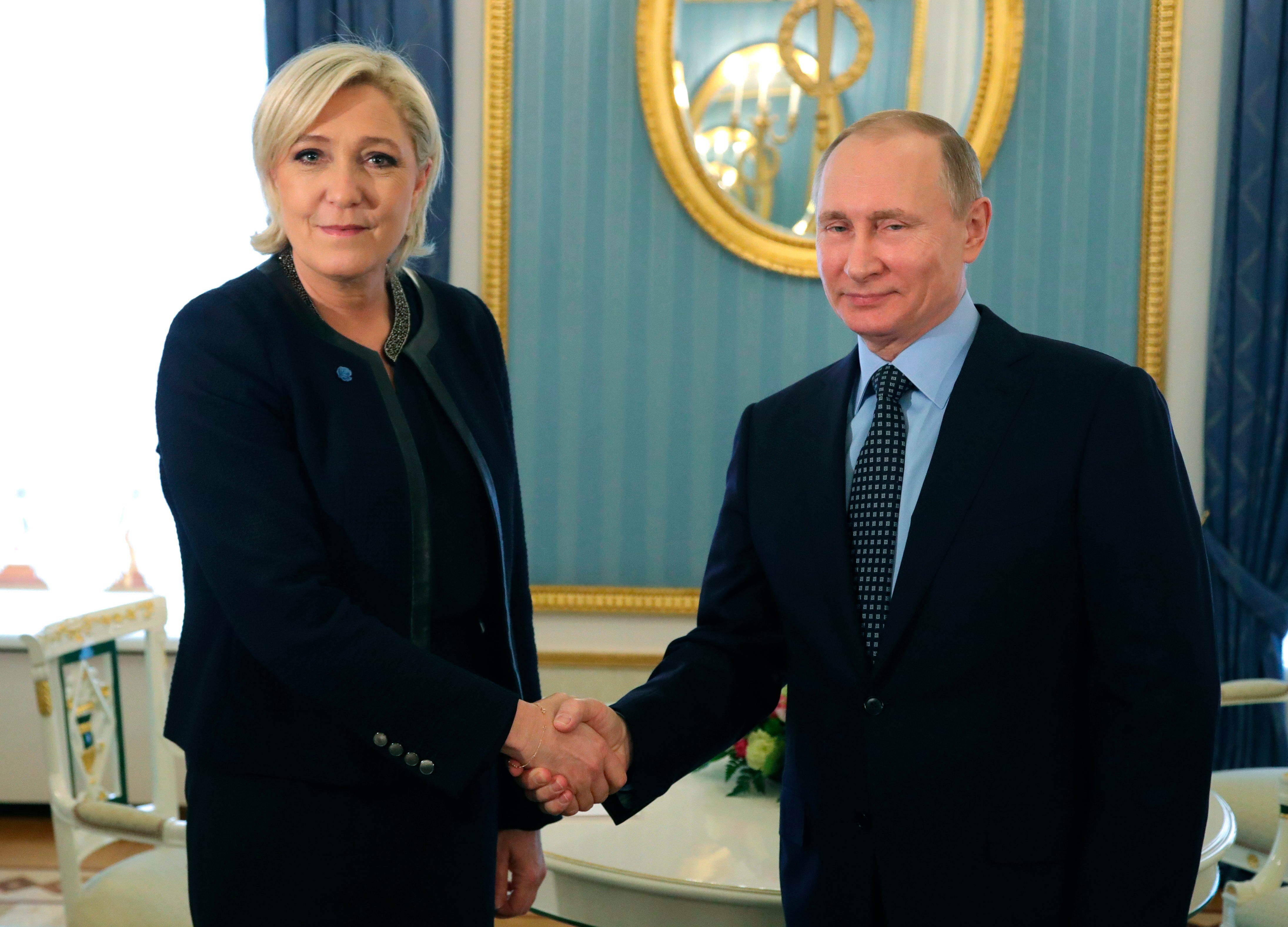 Vladimir Putin shakes hands with Marine Le Pen at the Kremlin in 2017