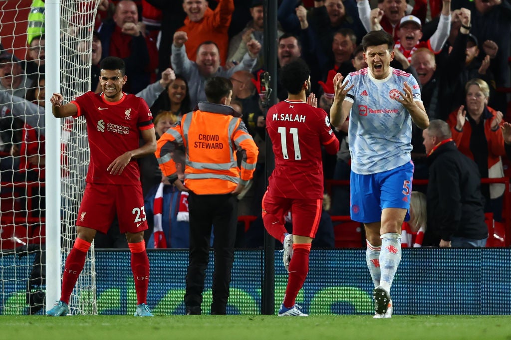 United’s Harry Maguire shows his frustration as Mo Salah celebrates his second goal for Liverpool