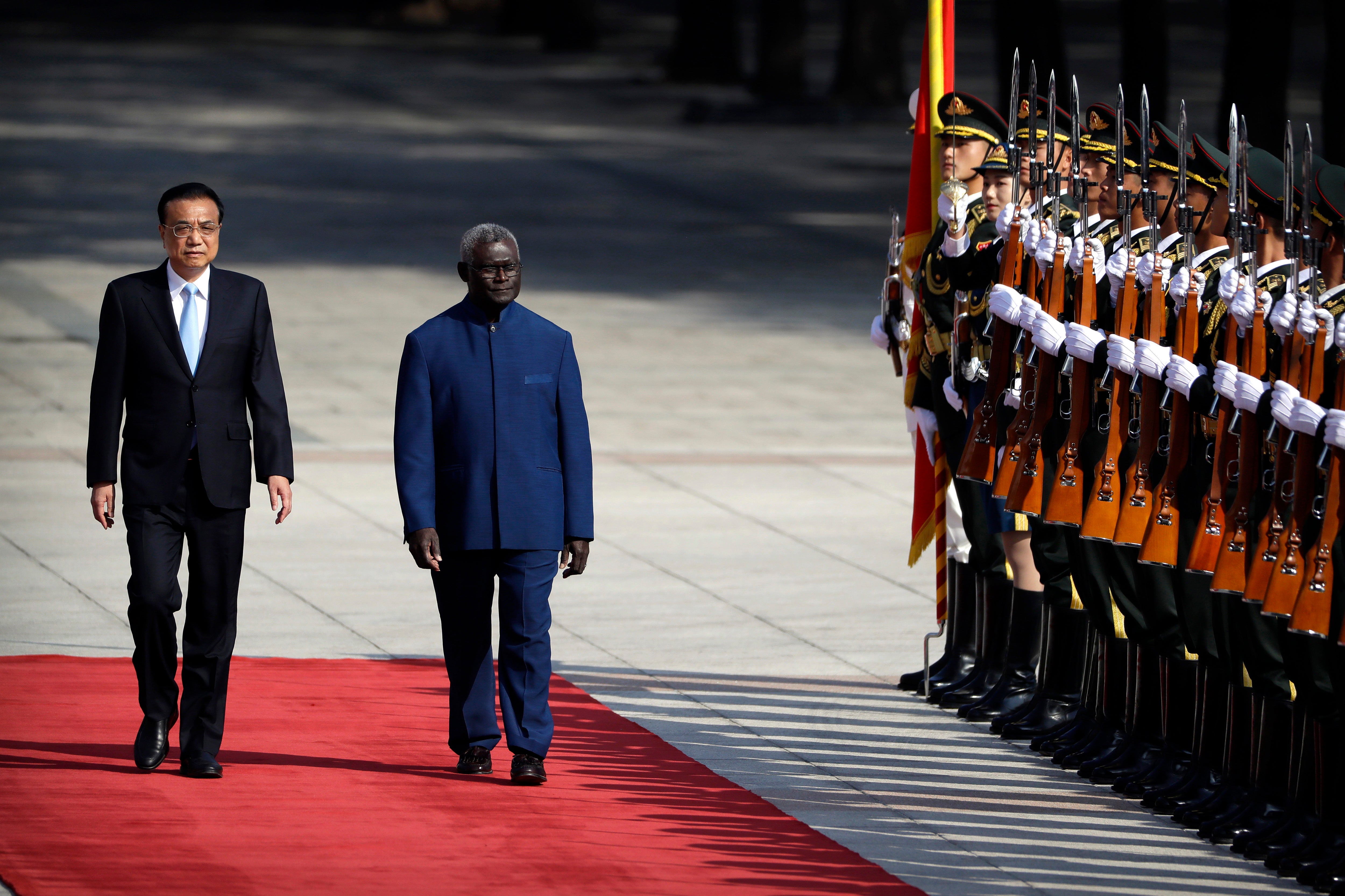 Chinese premier Li Keqiang and Mr Sogavare review an honour guard during a welcoming ceremony at the Great Hall of the People in Beijing in October 2019