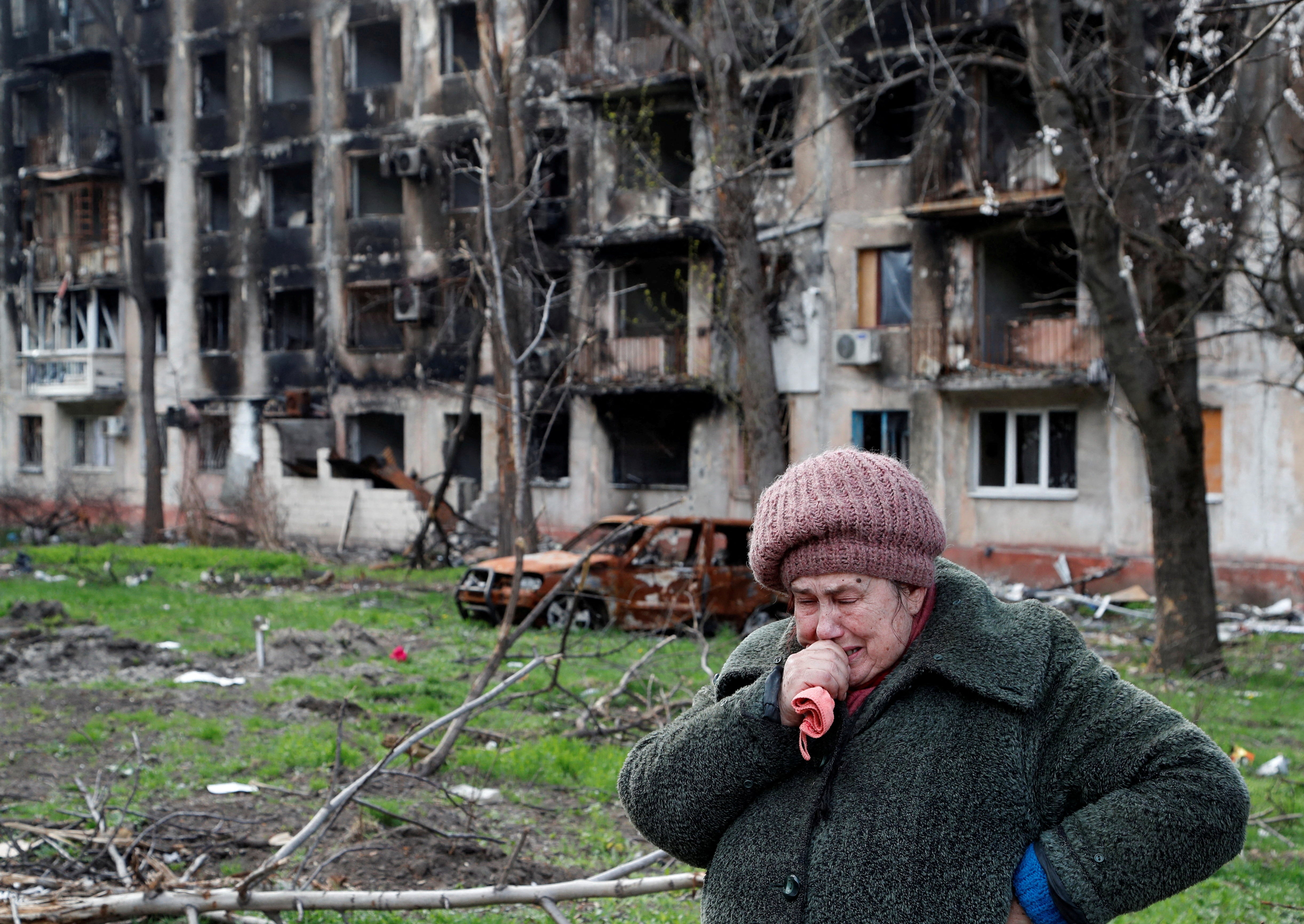 Local resident Tamara, 71, cries in front of an apartment building destroyed during the Ukraine-Russia conflict in the southern port city of Mariupol