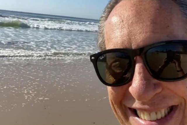 <p>Richard E Grant on the beach in Australia’s Gold Coast</p>