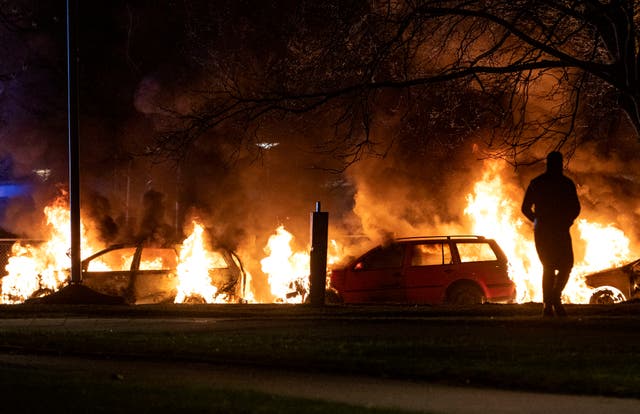 <p>Cars are engulfed by flames after protests broke out at Rosengard in Malmo, Sweden, April 17, 2022</p>