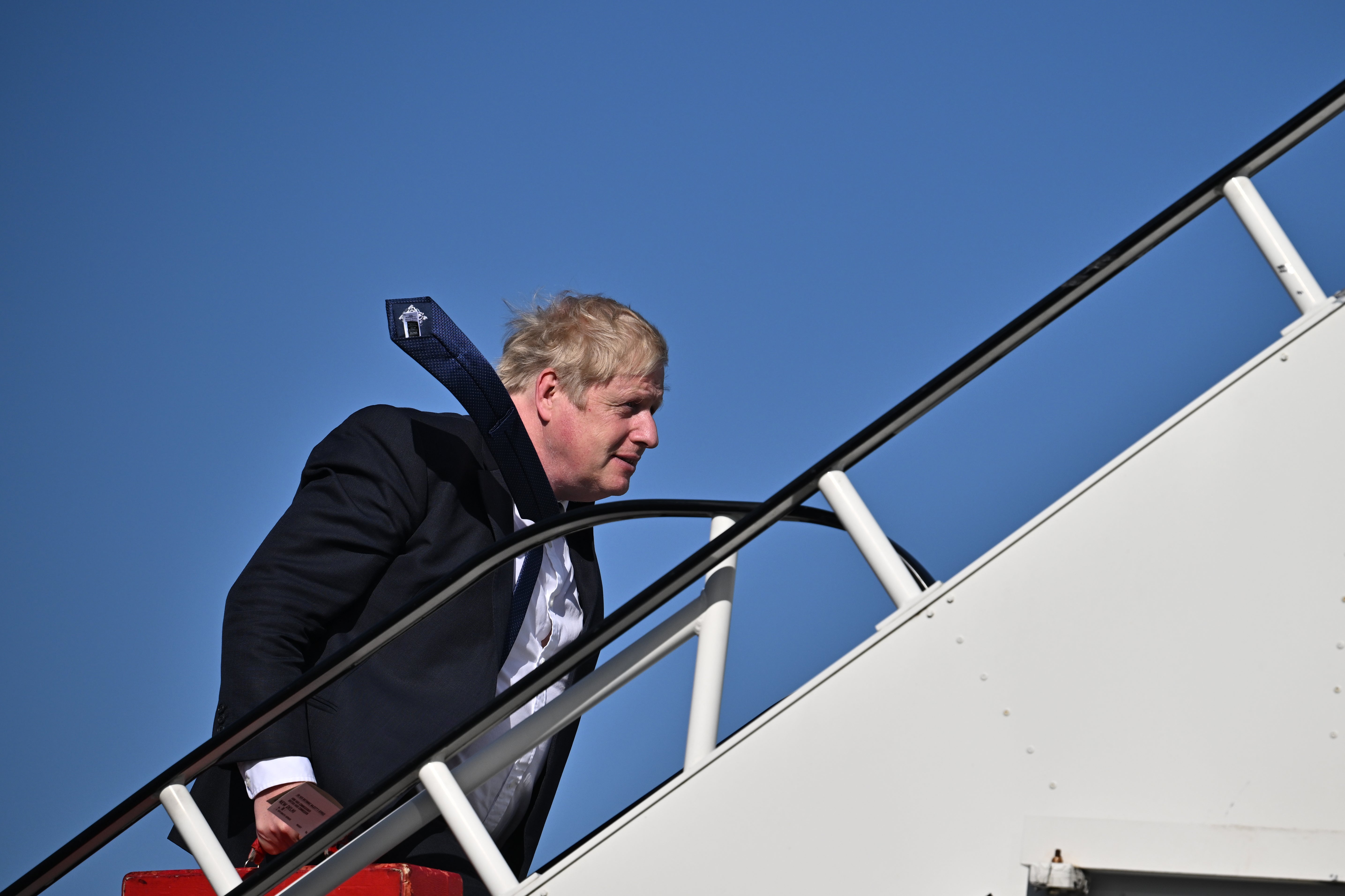 Boris Johnson boards a flight at Stansted as the Partygate crisis rumbles on