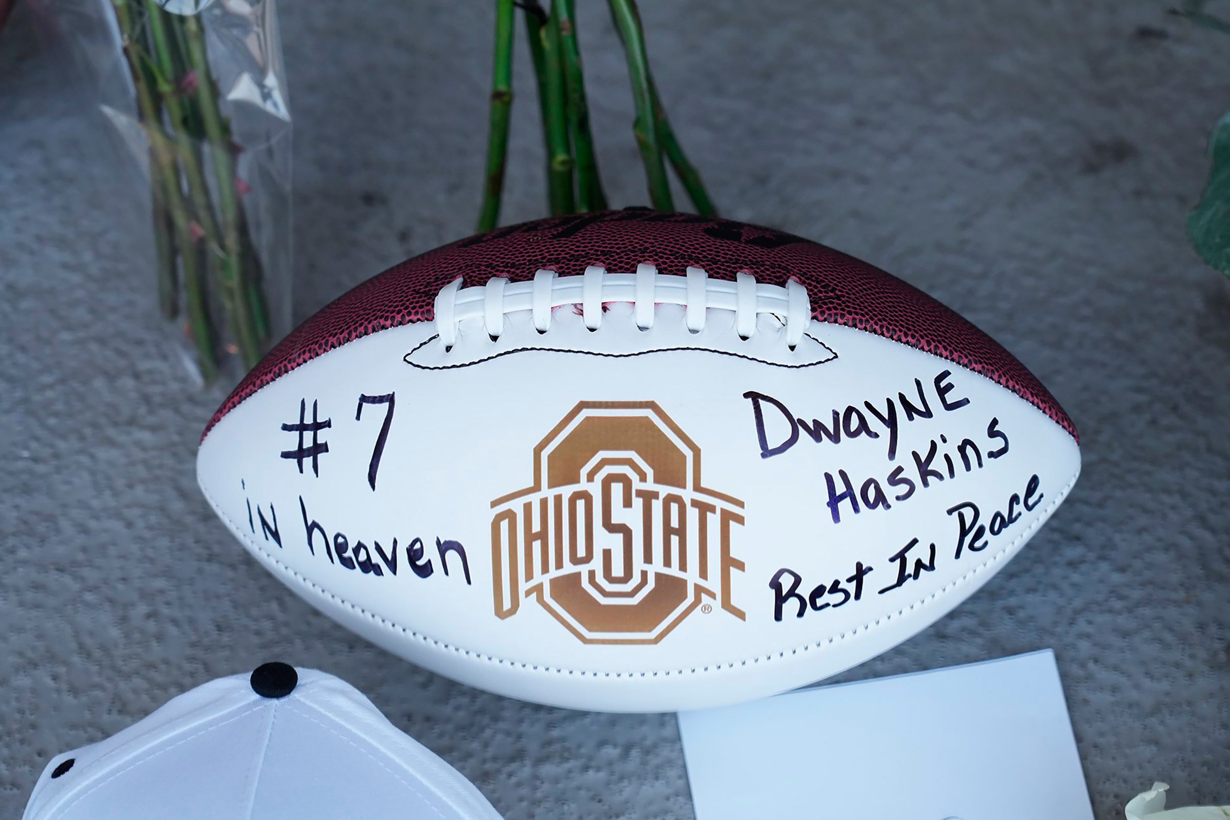 Mary Ellen Curzon-Price of Columbus left this football, roses, and other items at a makeshift memorial for former Ohio State football player and Pittsburgh Steelers quarterback Dwayne Haskins, at a memorial at Ohio Stadium on the campus of Ohio State University.