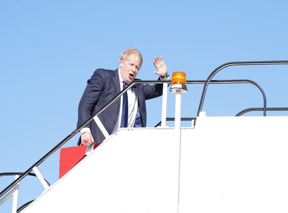 Prime Minister Boris Johnson boards a plane at Stansted Airport as he departs for a visit to India (Stefan Rousseau/PA)