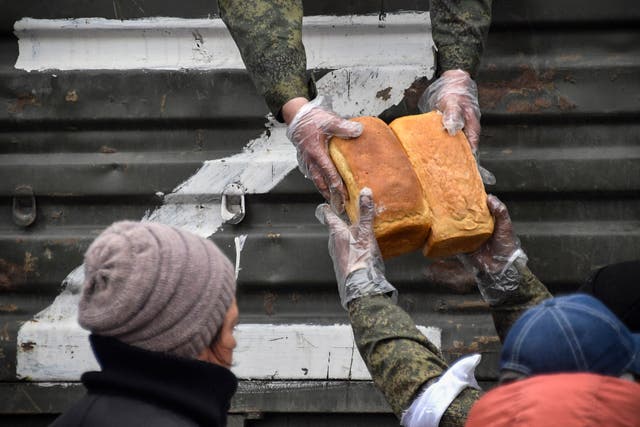 <p>Russian soldiers and volunteers distribute bread in Mariupol as Russian troops intensify a campaign to take the strategic port city </p>
