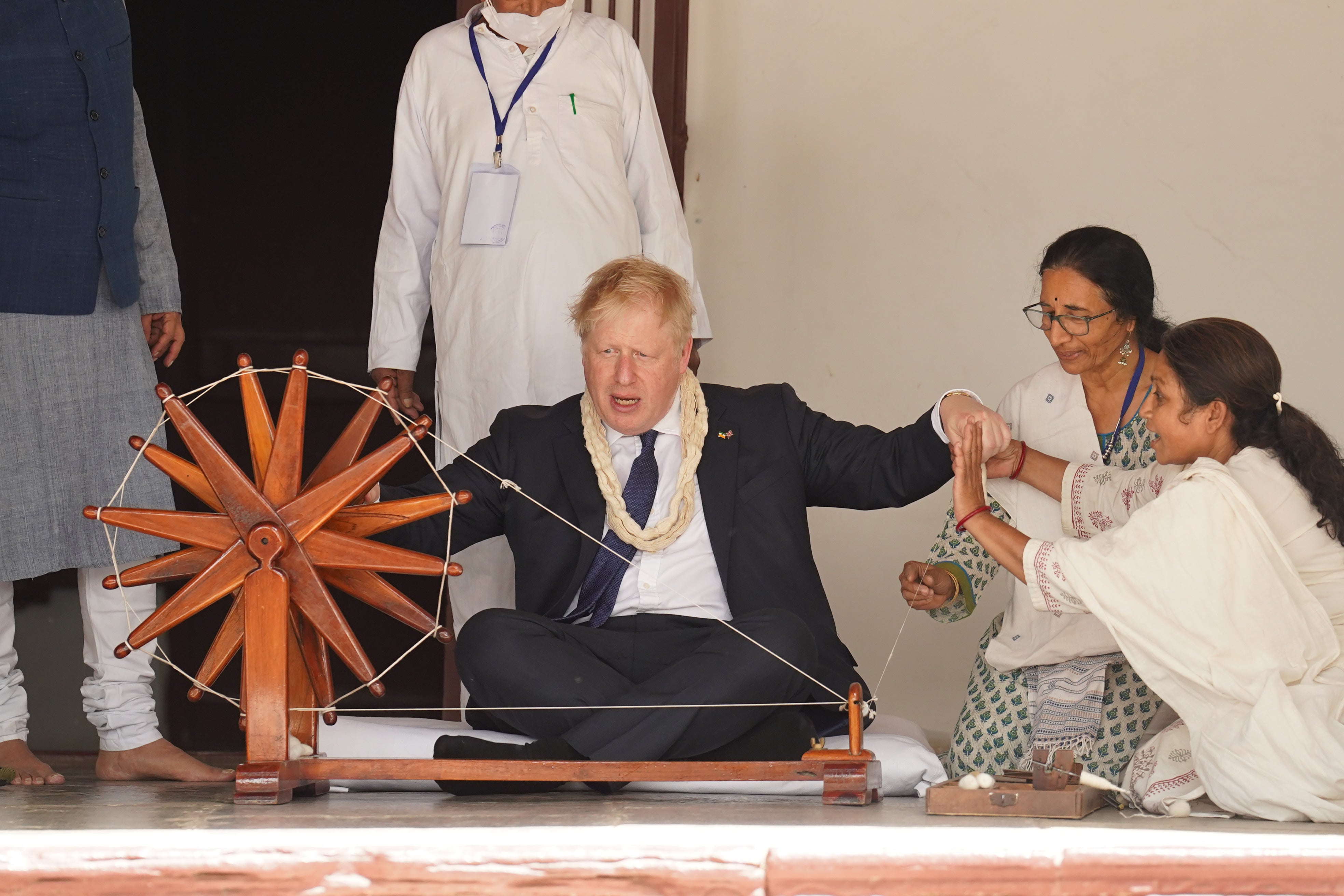The Prime Minister was show how to operate a cotton wheel (Stefan Rousseau/PA)