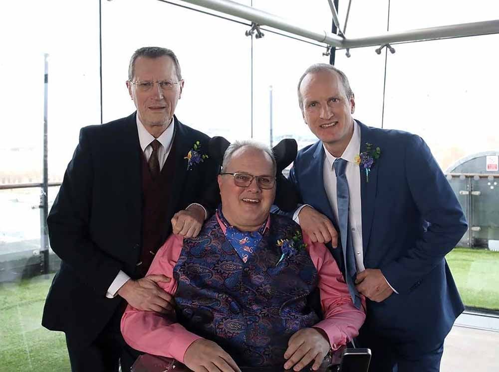 Marcus pictured with his two brothers, Adrian (on the left) and the groom, James (on the right). (Collect/PA Real Life)