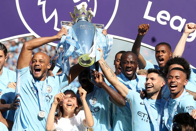 Vincent Kompany, left, and Sergio Aguero, right, lift the Premier League trophy together (Martin Rickett/PA)